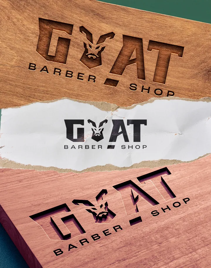 G.O.A.T. Barbershop logo applied to wood and paper